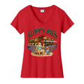 Front of a women’s red Sloppy Joe’s holiday V-neck tee showing the bar building wrapped in plaid with a red bow and wreaths, Santa in a Hawaiian shirt waving from a beach chair, and a rooster in a Santa hat